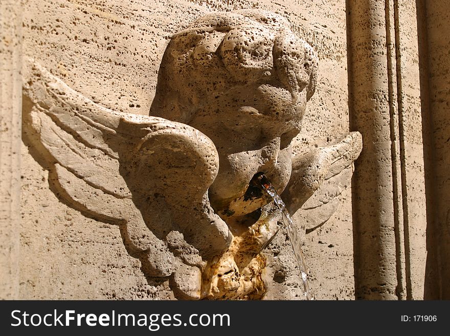 An angel shaped fountain in Rome in Italy. An angel shaped fountain in Rome in Italy