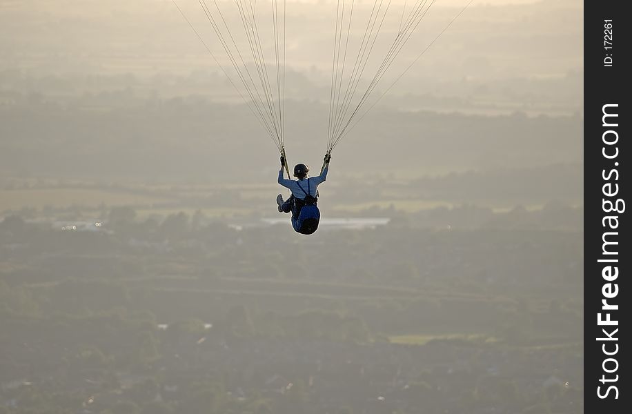 Paraglider fying high over the English countryside. Paraglider fying high over the English countryside