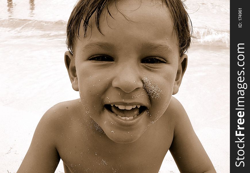 Little boy on beach smiling