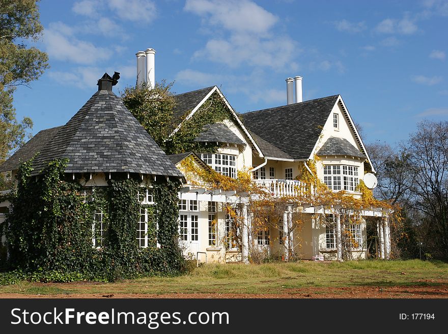 Country style house grown over by plants