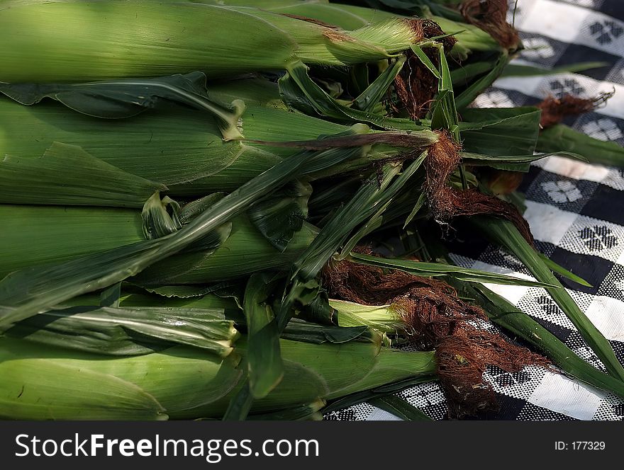 Corn sitting on a picnic table. Corn sitting on a picnic table.