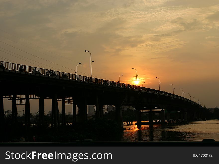 Horizontal view of a train bridge crossing a Red river. Horizontal view of a train bridge crossing a Red river