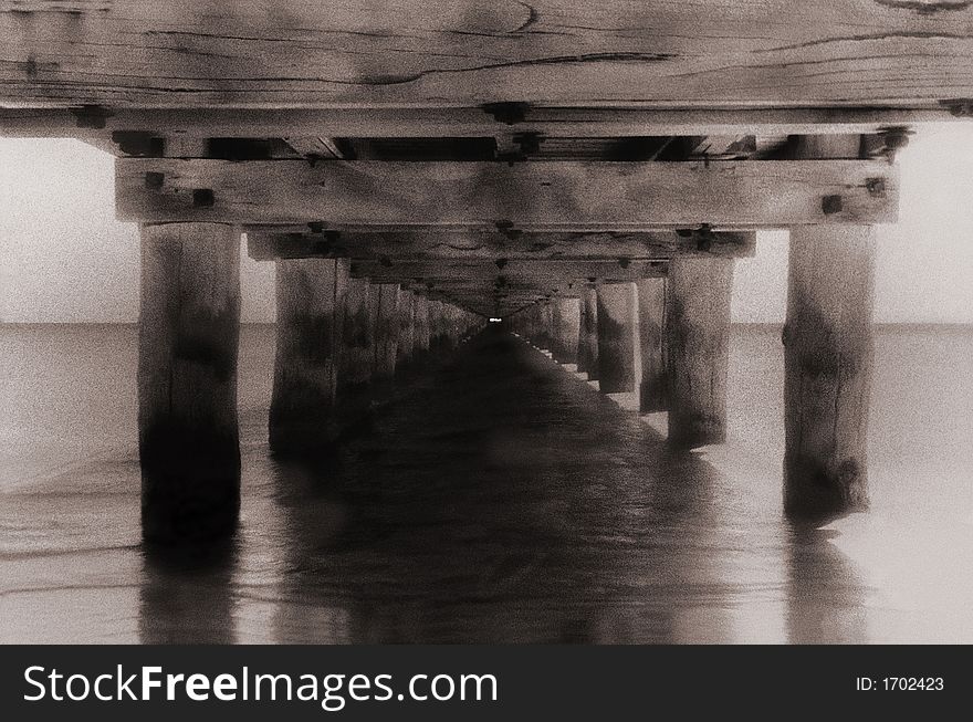 Boat pier at sea with converging lines infra red