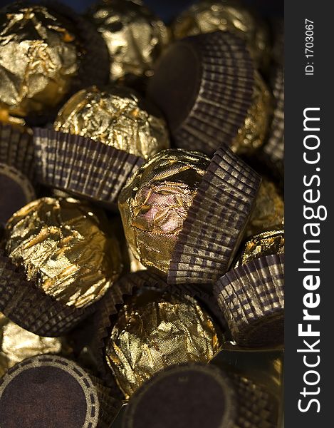 A collection of luxury chocolates wrapped in a golden foil