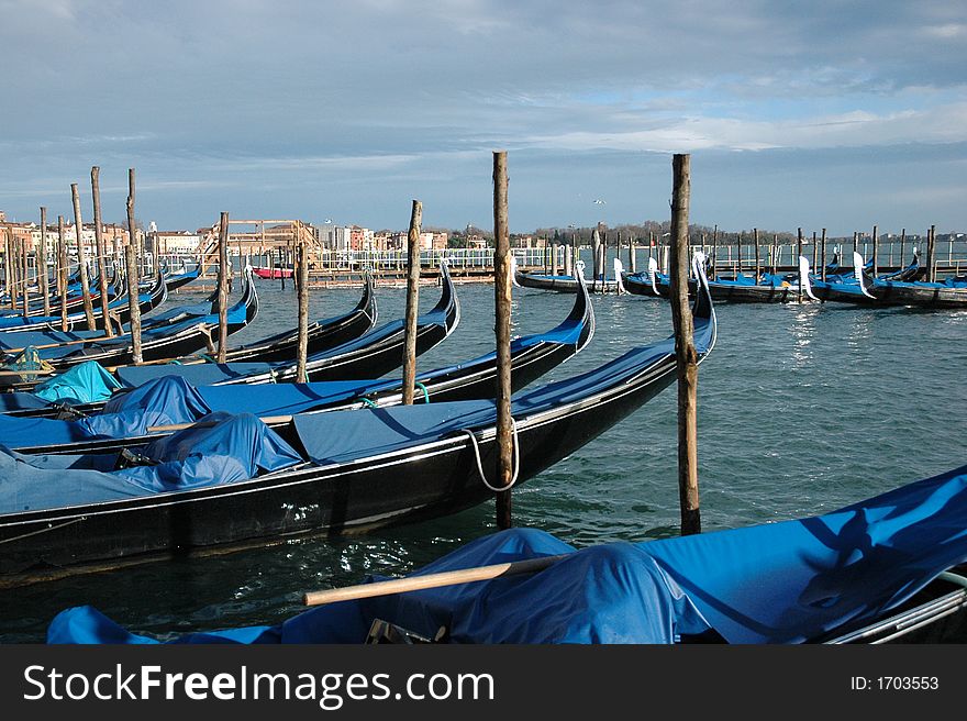 Several blue boats stoped in a small harbor in venice. Several blue boats stoped in a small harbor in venice.