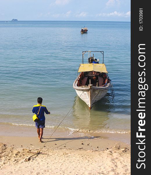 A driver and longboat taxi on a thai beach