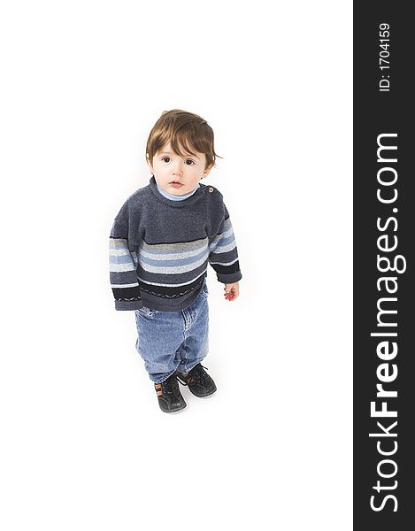 Baby with blue pullover standing over white background. Baby with blue pullover standing over white background