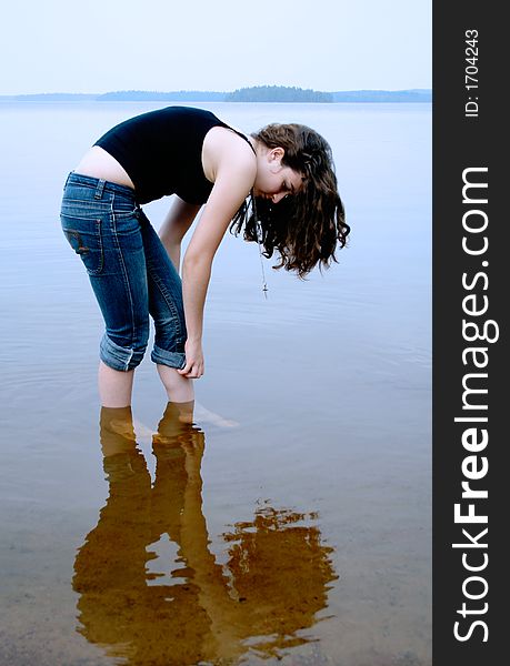 Girl standing in shallow water. Girl standing in shallow water