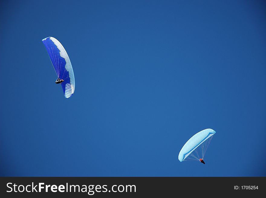 Two paragliders on perfect blue New Zealand sky . Two paragliders on perfect blue New Zealand sky