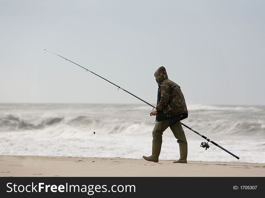 Fisherman walking by the coastline