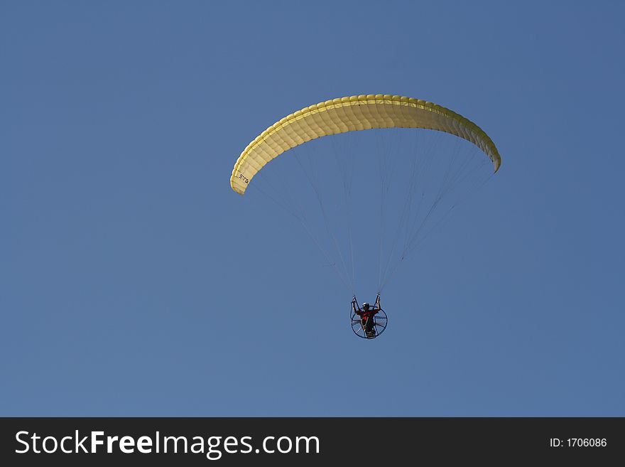Paraglider with engine over a blue sky . Paraglider with engine over a blue sky
