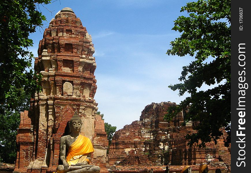 Meditating buddha statue with yellow wrap