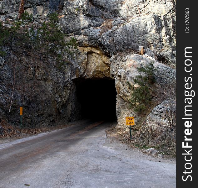 A road leading to a tunnel in a mountain