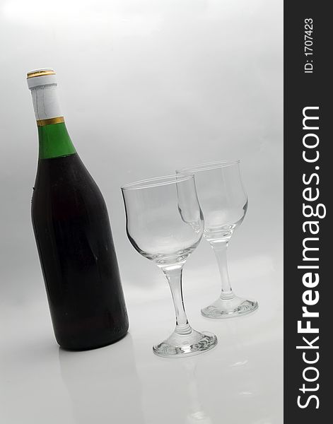 Red wine bottle and two glasses background