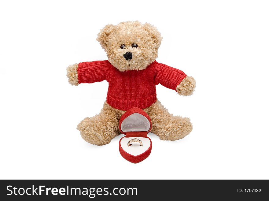 Teddy bear offering an engagement ring in a red heart shaped box for valentine's. Teddy bear offering an engagement ring in a red heart shaped box for valentine's