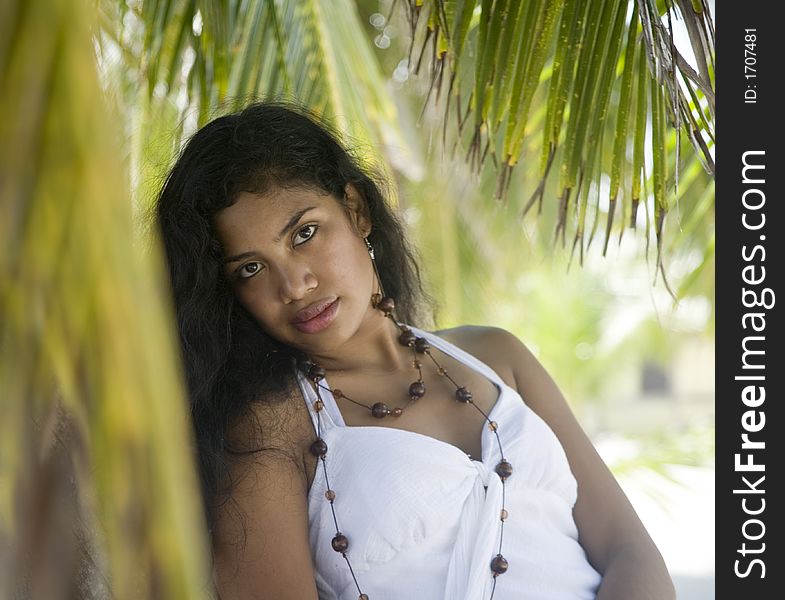 Beautiful Girl Waiting By A Palm Tree