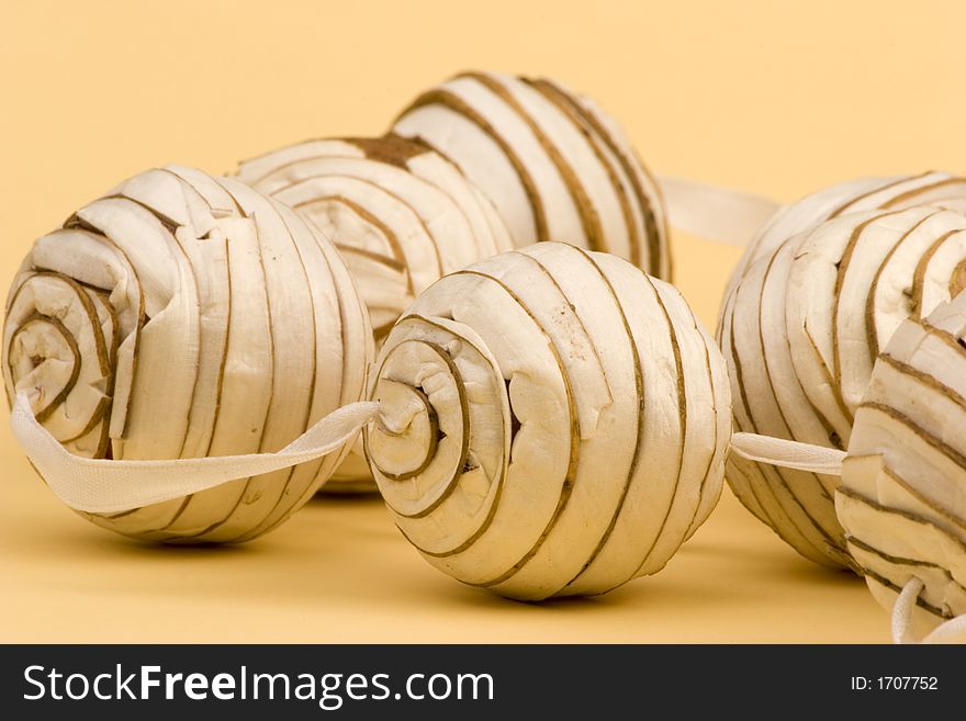 Decorative Christmas paper balls against a plain background.