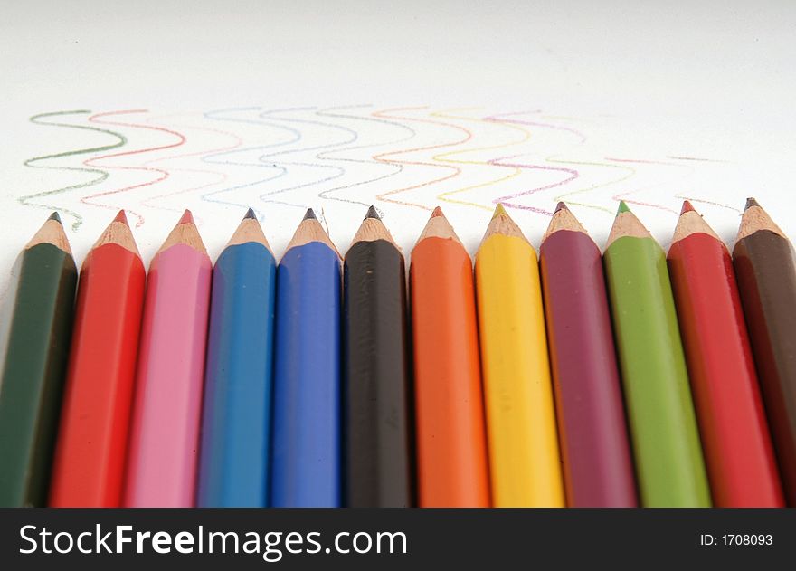 Row of coloured pencils with wavy drawn lines