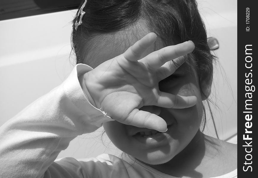 A girl covering her eyes from direct sunlight