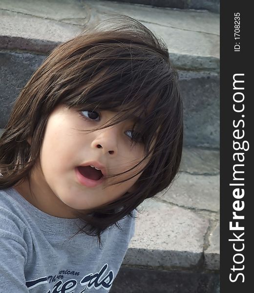 Little girl with long hair during a windy day