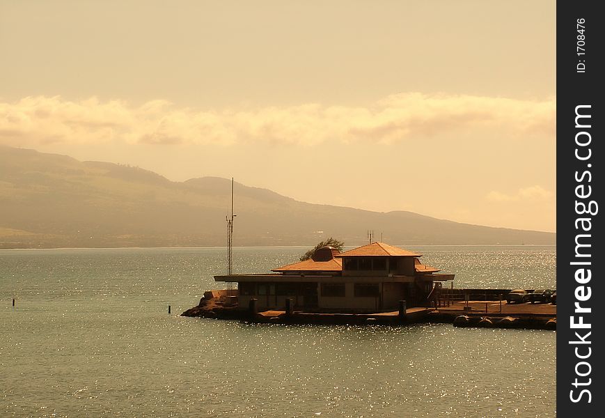 View of a pier at oceanic bay, view of mountains in the background. View of a pier at oceanic bay, view of mountains in the background