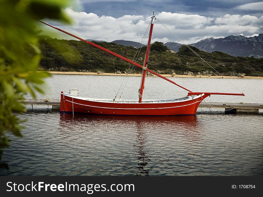 Boat anchored in a harbour on a cloudy day. Boat anchored in a harbour on a cloudy day