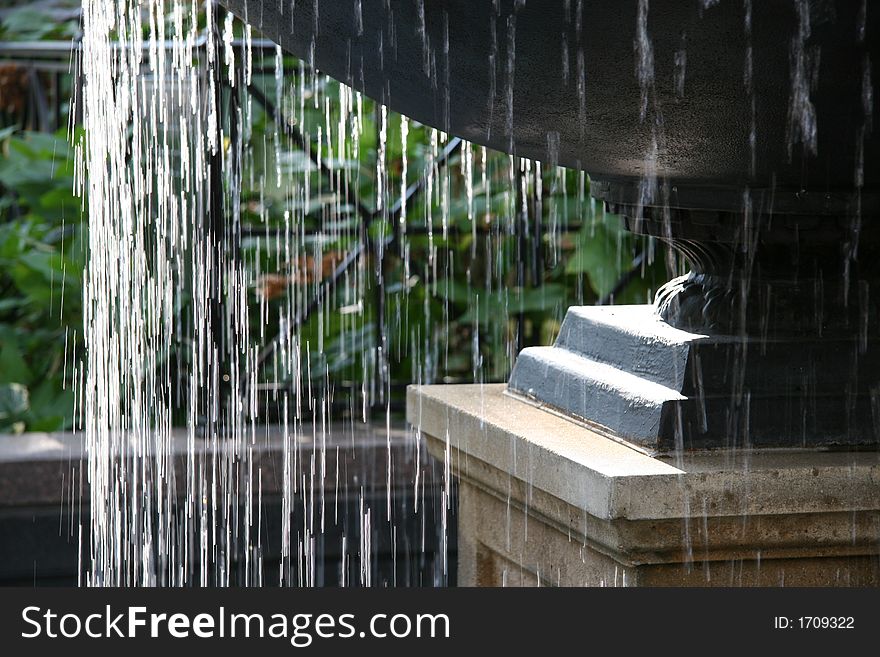 A relaxing water fountain.  Water flowing over the edge. A relaxing water fountain.  Water flowing over the edge.