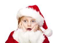 Small Girl Dressed As Santa Claus Looks Surprised Royalty Free Stock Images