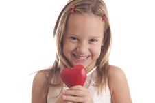 Girl Holds Heart And Smiles Stock Photo