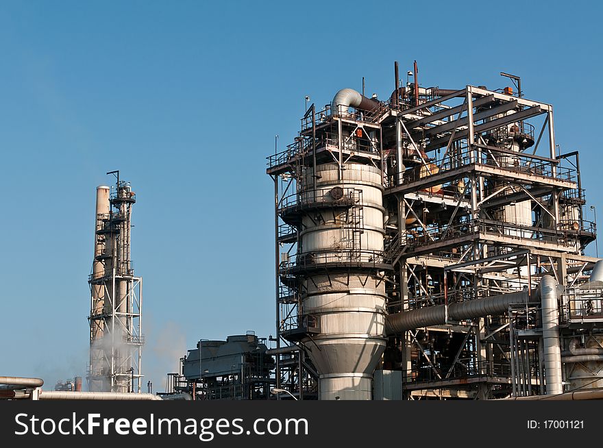 A petrochemical refinery plant with pipes and cooling towers.