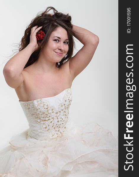 Smiling bride in wedding dress and berries in her hair