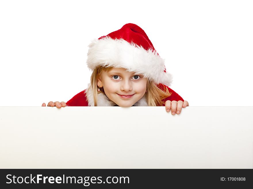 Small girl dressed as santa claus holds blank advertisement sign. Isolated on white background. Small girl dressed as santa claus holds blank advertisement sign. Isolated on white background.