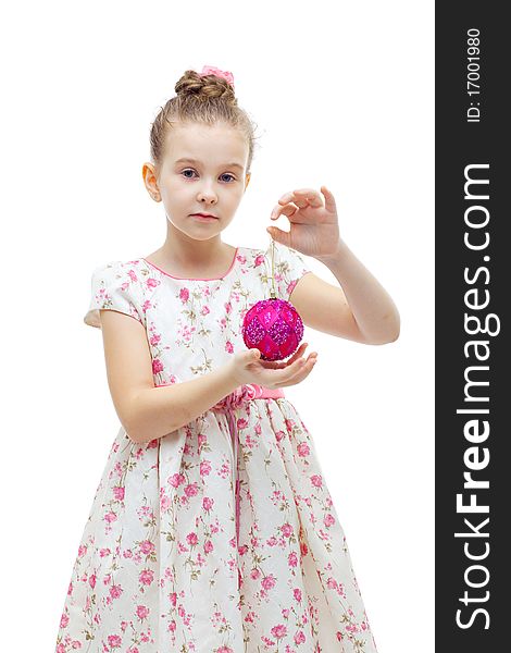 Cute little girl in dress playing with a christmas-tree decoration on white background isolated