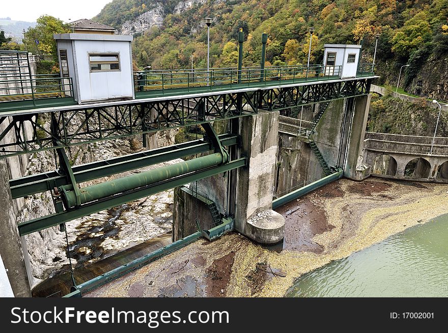 A dam with hydroelectric plant in a mountain river