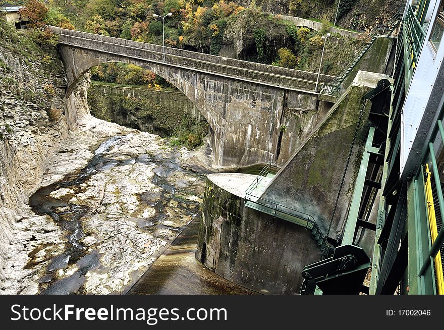 A dam with hydroelectric plant in a mountain river. A dam with hydroelectric plant in a mountain river