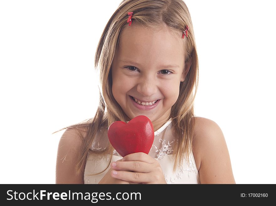 The girl holds one red heart and smiling on white background. The girl holds one red heart and smiling on white background