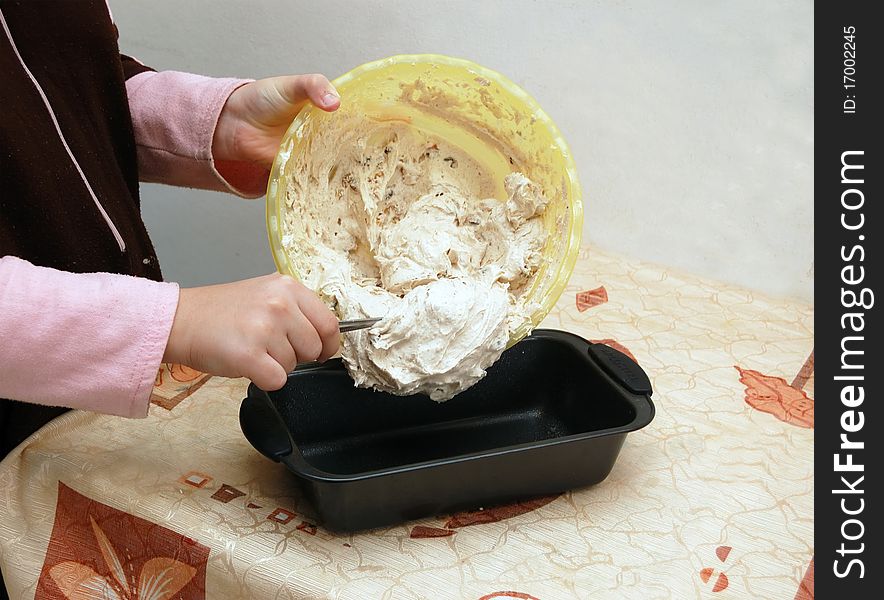 Putting a dough into a cake pan