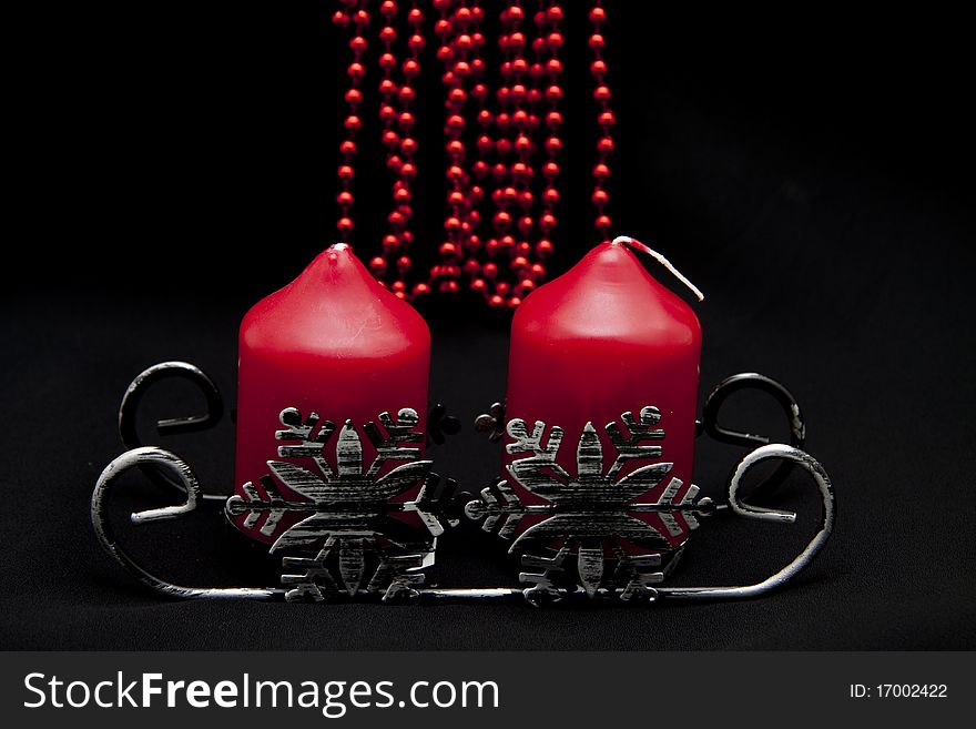 Christmas sledge with candles onto black background