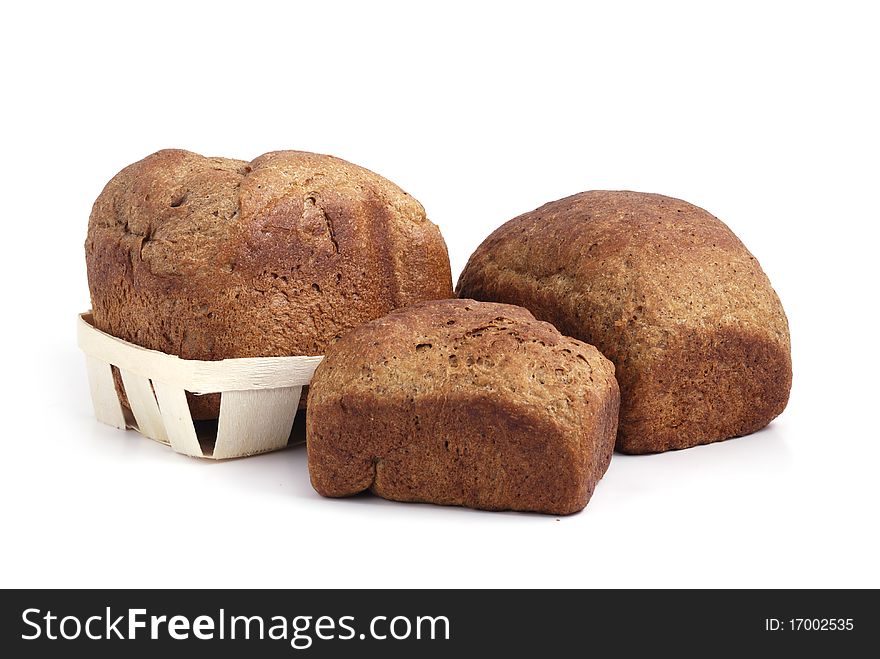 Homemade wheat bread in a basket on white background. Homemade wheat bread in a basket on white background