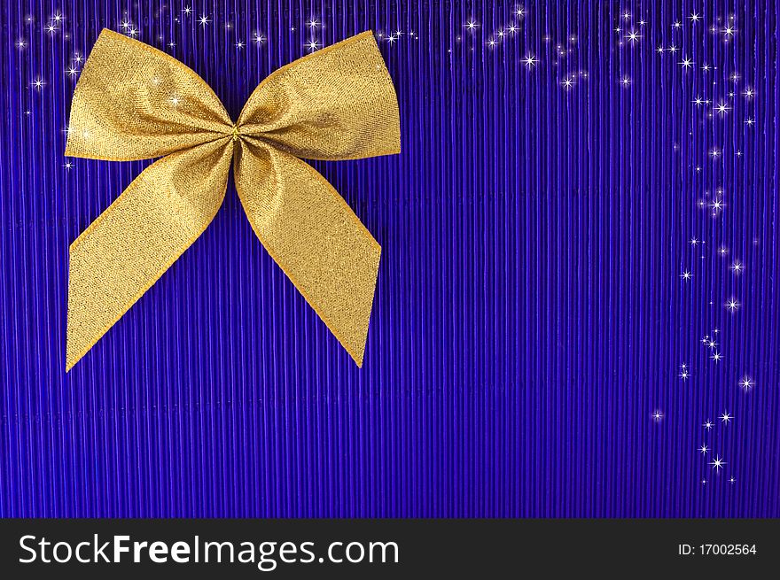 Gold bow on blue background. Gold bow on blue background.