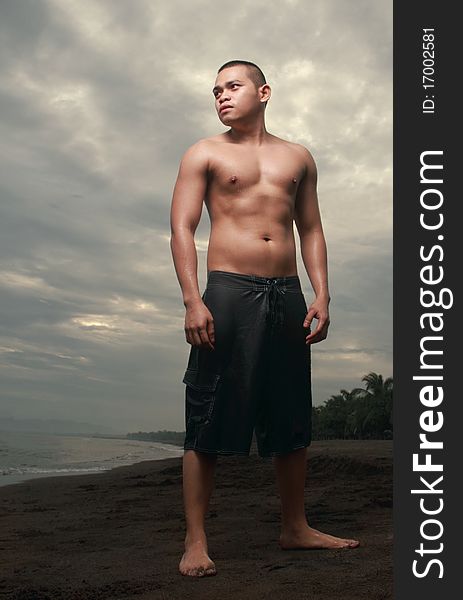 Asian man standing at the beach. Asian man standing at the beach