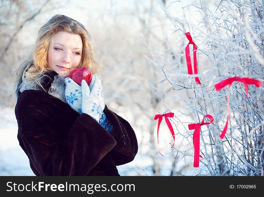 Winter girl behind snow tree