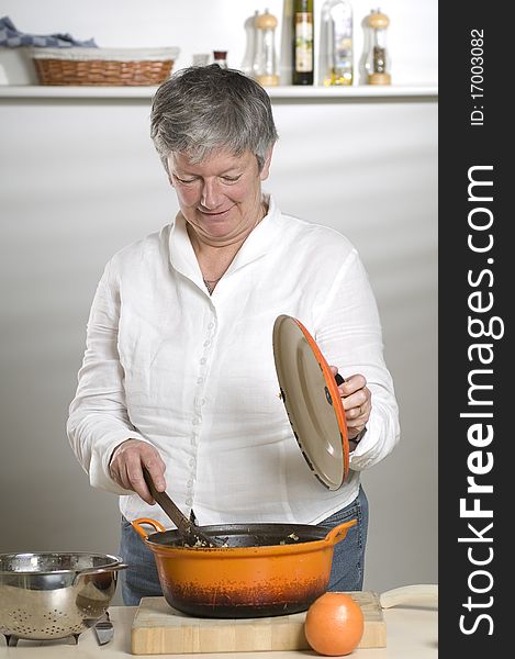 Women is cooking food in a orange pan