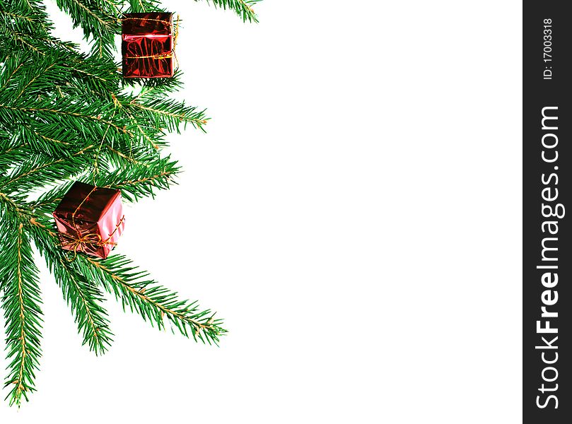 Fur-tree branch with small presents on a white background