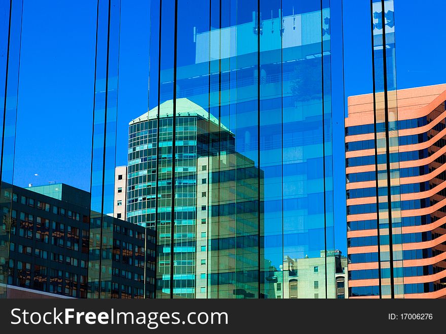 Skyscrapers, towers and reflection in the glass on blue sky. Skyscrapers, towers and reflection in the glass on blue sky