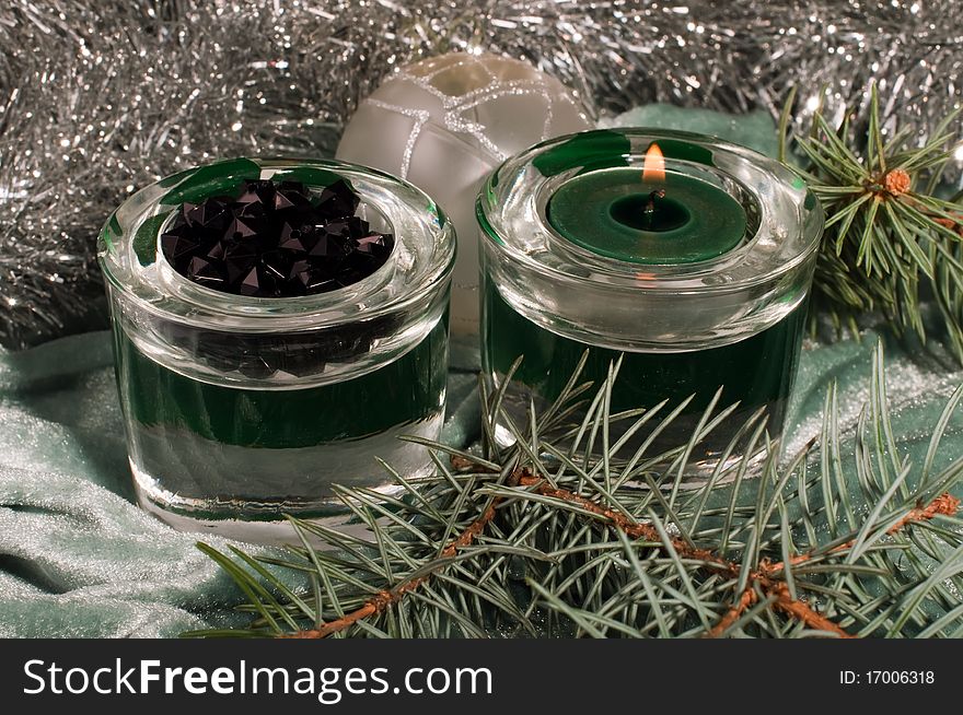 Burning candle with christmas decorations