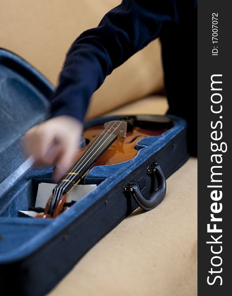 Boy's hand taking a violin