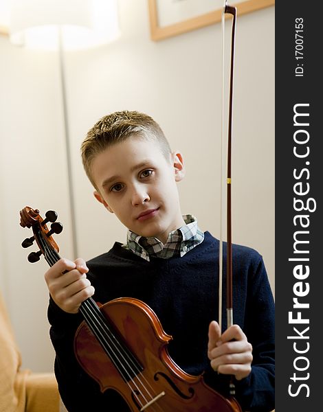 Young boy with his violin at home