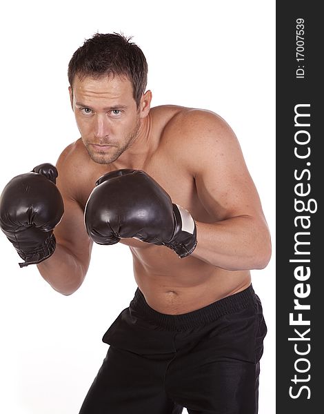 A close up of a man in boxing gloves with a serious expression on his face. A close up of a man in boxing gloves with a serious expression on his face.