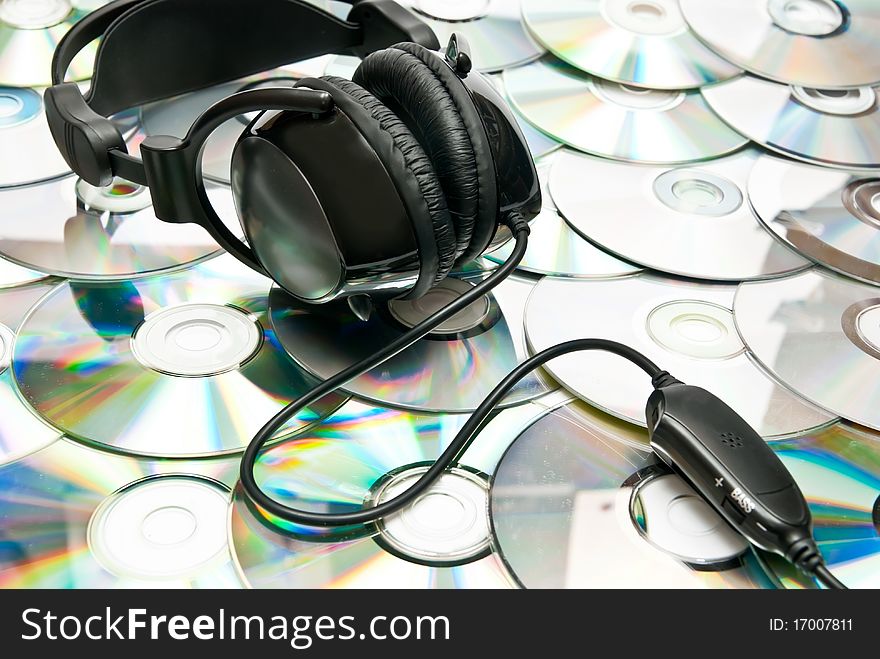 Black headphones on cd background. Studio shot. Black headphones on cd background. Studio shot